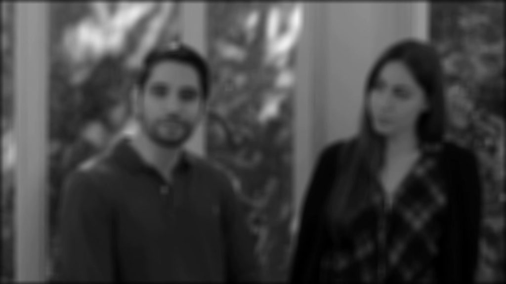 Two blurry people standing next to eachother